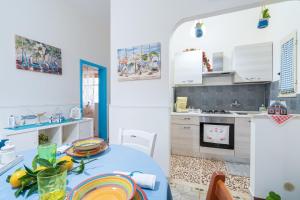 a kitchen with a blue table in a room at Villetta Granelli in Granelli +17 photos