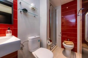 a bathroom with a white toilet and a sink at Gala in Cala Ratjada +15 photos