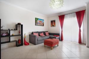 a living room with a gray couch and red pillows at A O - Ferrel House Casual in Ferrel