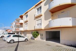 a white car parked in front of a building at A O - Ferrel House Casual in Ferrel