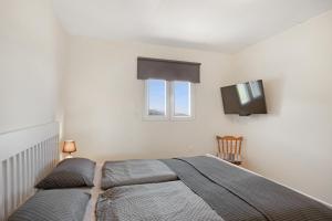 a bedroom with a bed and a flat screen tv at Fewo Arafo in Güimar