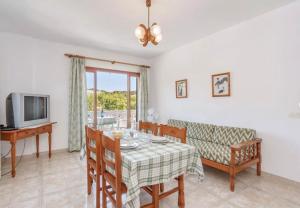 a living room with a table and a couch at La Cabanya Apartment 3d in Canyamel