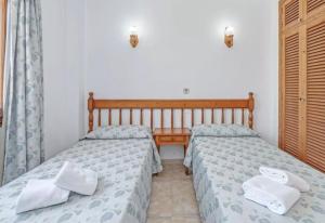 two beds sitting next to each other in a bedroom at La Cabanya Apartment 3d in Canyamel +13 photos