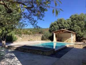 a swimming pool with a gazebo in a yard at Mas Les Coutilles in Cabrières-dʼAvignon +28 photos