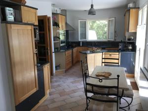 a kitchen with a table and chairs in a room at Mas Les Coutilles in Cabrières-dʼAvignon