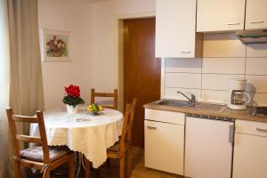 a small kitchen with a table with a table cloth at Haus zur Bienenweide in Schömberg