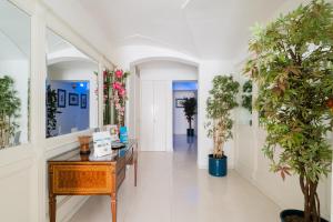 a hallway with a desk and potted plants at Palazzo Mongiò in Gallipoli