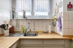 a kitchen with a sink and a window at Fewo Waldfee in Höchenschwand +16 photos