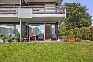 a house with a table and chairs on a lawn at Fewo Waldfee in Höchenschwand