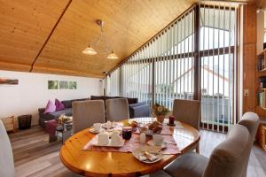 a living room with a wooden table and a couch at Haus Müller in Böhringen