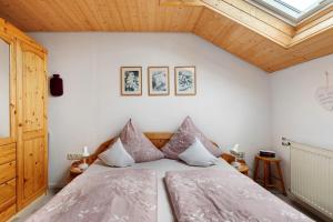 a bedroom with a bed with pillows on it at Haus Müller in Böhringen