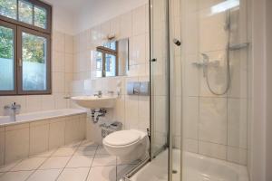 a bathroom with a toilet and a shower and a sink at Effi-Briest-Villa in Heringsdorf +22 photos