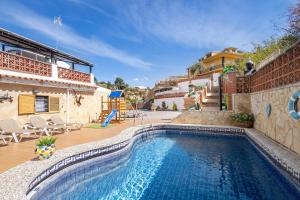 a swimming pool in front of a house at Cal Ramon con piscina in Rubí