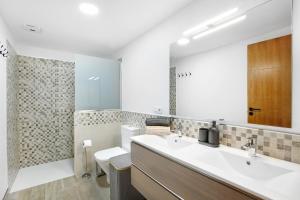 a bathroom with a sink and a toilet and a mirror at Casa Marhec in Sauzal +18 photos