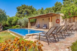 a group of chairs sitting next to a swimming pool at Son Del Rio Nou in Pollença