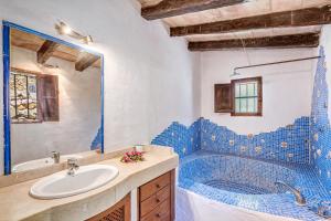 a bathroom with a sink and a blue tile tub at Son Del Rio Nou in Pollença +28 photos