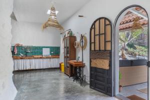 a room with a door and a desk and a window at Casa Cueva Rural, Calima in Juncalillo +27 photos