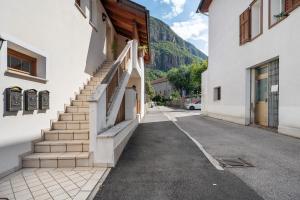 a street in a town with white buildings at Honey Home With Parking in Laives