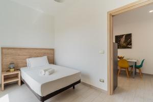 a bedroom with a bed and a table and a mirror at Le scuderie 10 in Galatone