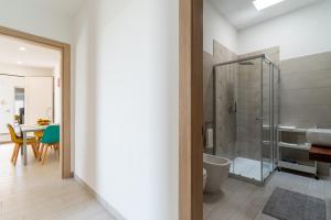 a bathroom with a shower and a toilet and a table at Le scuderie 10 in Galatone +24 photos