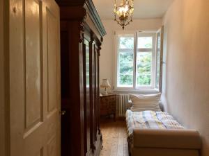 a hallway with two beds in a room with a window at Villa Buselmeier in Neuried