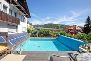 a swimming pool in the backyard of a house at Villa Sonnenwinkel in Todtmoos