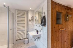 a white bathroom with a sink and a shower at Zuhaus am See in Gstadt am Chiemsee +17 photos