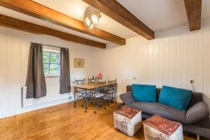 a living room with a couch and a table at Zuhaus am See in Gstadt am Chiemsee