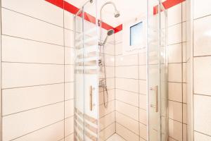 a shower with a glass door in a bathroom at Arianna Studio Ground Floor 2 in Paleokastritsa +15 photos