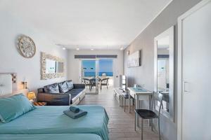a bedroom with a bed and a living room with a table at Las Flores 407 in Playa Fañabe