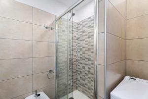 a bathroom with a shower and a toilet at Las Flores 407 in Playa Fañabe +16 photos