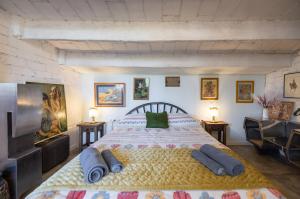 a bedroom with a large bed with two pillows on it at La Fabriqueta Apartament Loft in Ríudecañas