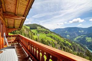 a balcony of a cabin with a view of the mountains at Ferienhaus Rauchegg - Bergblick in San Pancrazio dʼUltimo