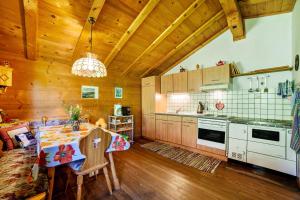a kitchen with a table and a dining room at Ferienhaus Rauchegg - Bergblick in San Pancrazio dʼUltimo +29 photos