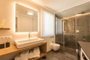 a bathroom with a sink and a shower at Apartment Roderer in Völs am Schlern +16 photos