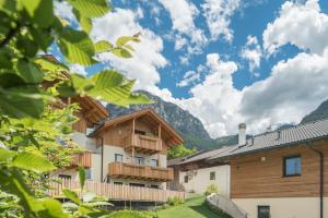 a group of buildings with mountains in the background at Apartment Roderer in Völs am Schlern