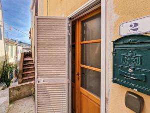 an entrance to a building with a door and a window at Il Borgo 4 in Capoliveri