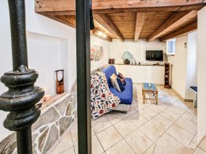 a living room with a blue chair and a table at Il Borgo 4 in Capoliveri
