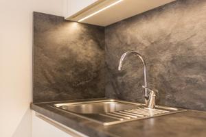 a kitchen sink with a faucet on a counter at Rosalpina Apt 1 in San Vigilio Di Marebbe