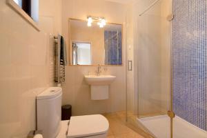 a bathroom with a toilet and a sink and a shower at Casa Allan in Vale do Lobo +17 photos