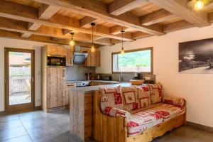 a kitchen with a couch in the middle of a room at Chalet du Piedmont in Cornimont
