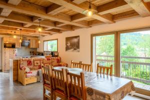 a kitchen and dining room with a table and chairs at Chalet du Piedmont in Cornimont +22 photos