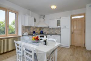 a kitchen with a table with a bowl of fruit on it at Casa Doss in Tremosine Sul Garda +33 photos