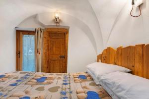 a bedroom with two beds in a room with a door at Logge dei Paroloti Paolo in San Lorenzo in Banale