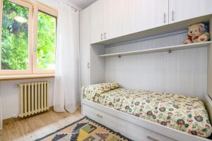 a small bedroom with a bed and a window at Casa Doss in Tremosine Sul Garda