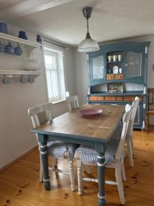 a dining room with a wooden table and chairs at Thüringer Landidyll in Bösleben-Wüllersleben +31 photos