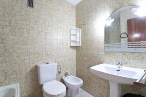 a bathroom with a white toilet and a sink at Casa La Roqueta in Guardamar del Segura +17 photos