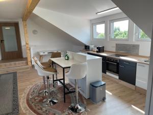 a kitchen with a table and chairs in a room at promedklinik apartment 3 in Volkach +7 photos