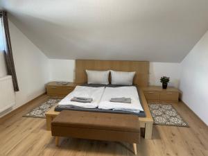 a bedroom with a bed with two towels on it at promedklinik apartment 3 in Volkach