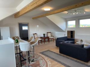 a living room with a couch and a table at promedklinik apartment 3 in Volkach